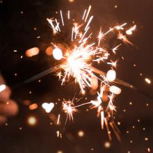 Two hands holding sparklers