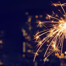 Sparkler with a city in the background