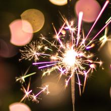 Pink sparkler on black background