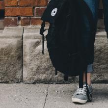 Student holding a backpack