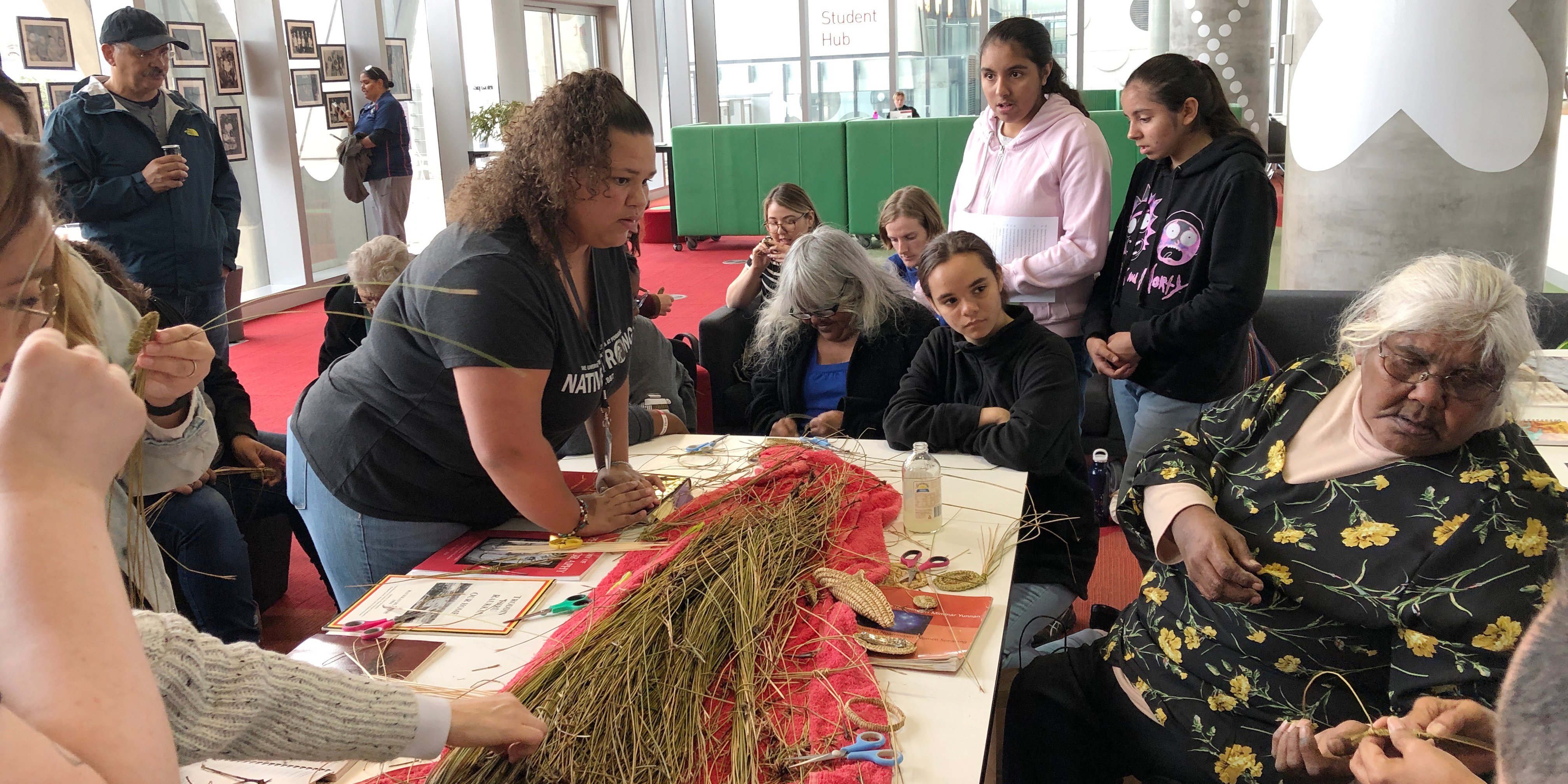 A group of students interacts with Australian Indigenous people.