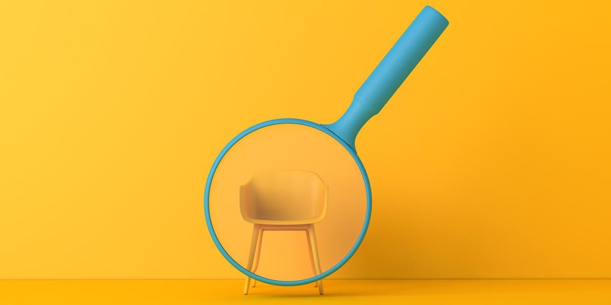 Blue magnifying glass over a yellow chair