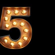 The number five in theater-style lights